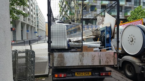 Professional team managing skip placement in Penge